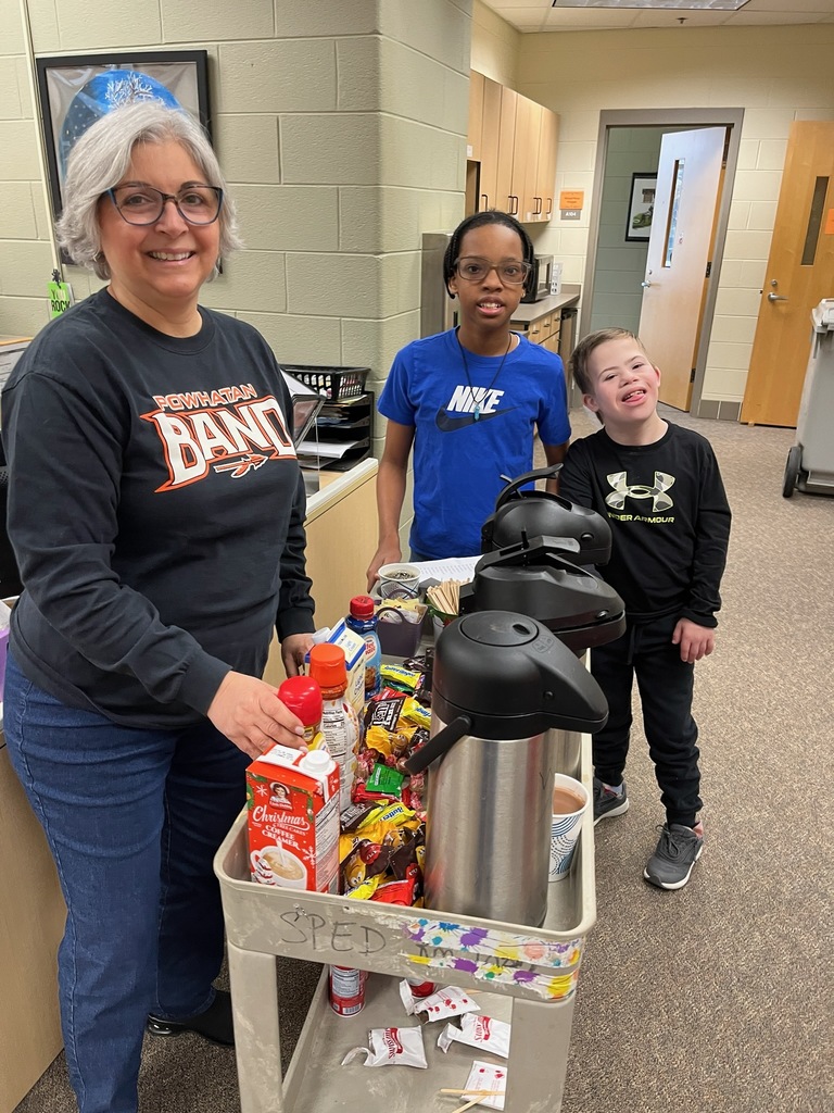 Students serve hot chocolate or coffee to school staff in a coffee train.
