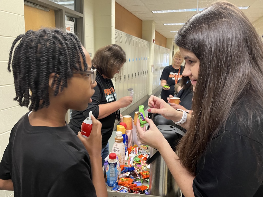 Students serve hot chocolate or coffee to school staff in a coffee train.