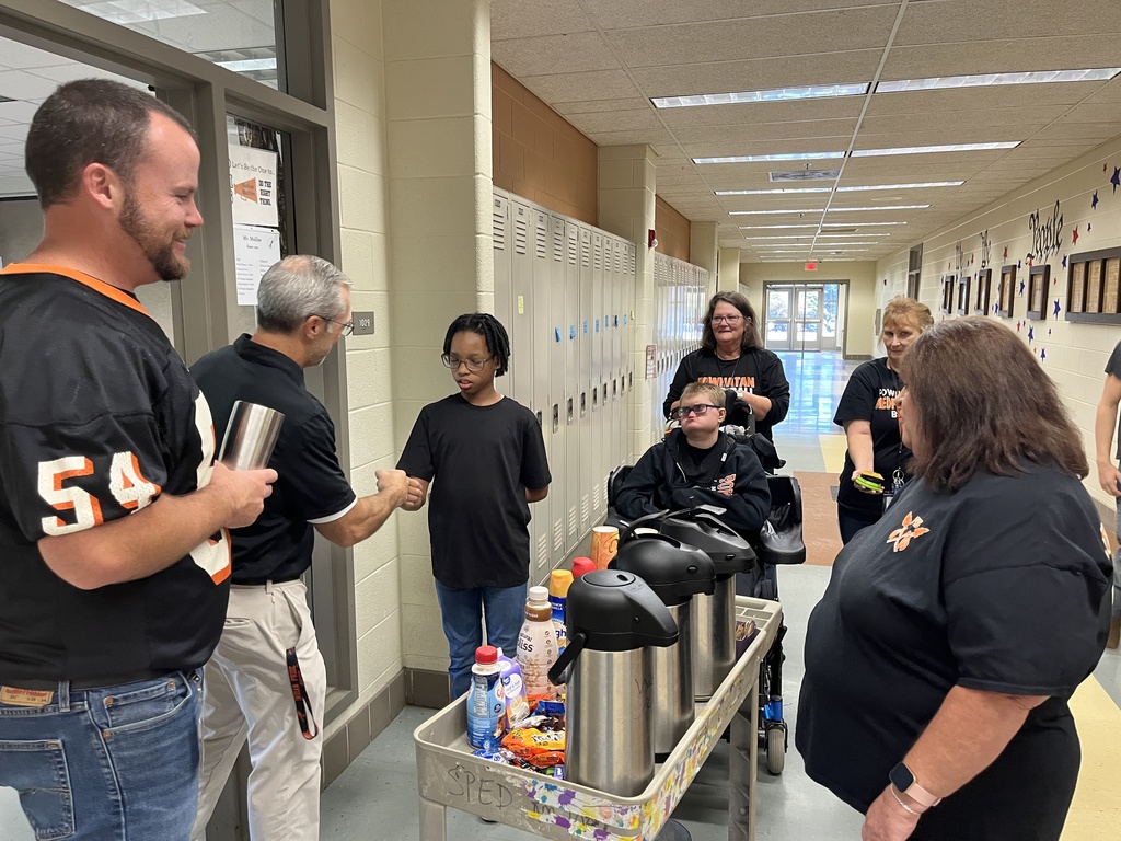 Students serve hot chocolate or coffee to school staff in a coffee train.
