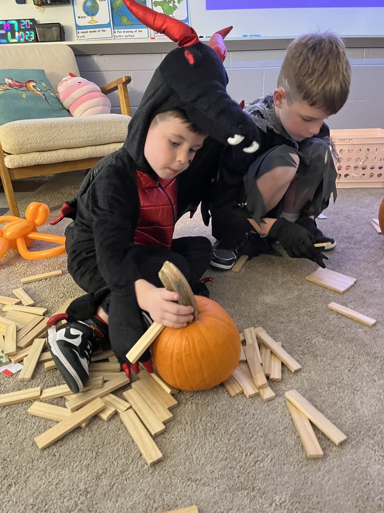 Children play in an activity at a fall festival.