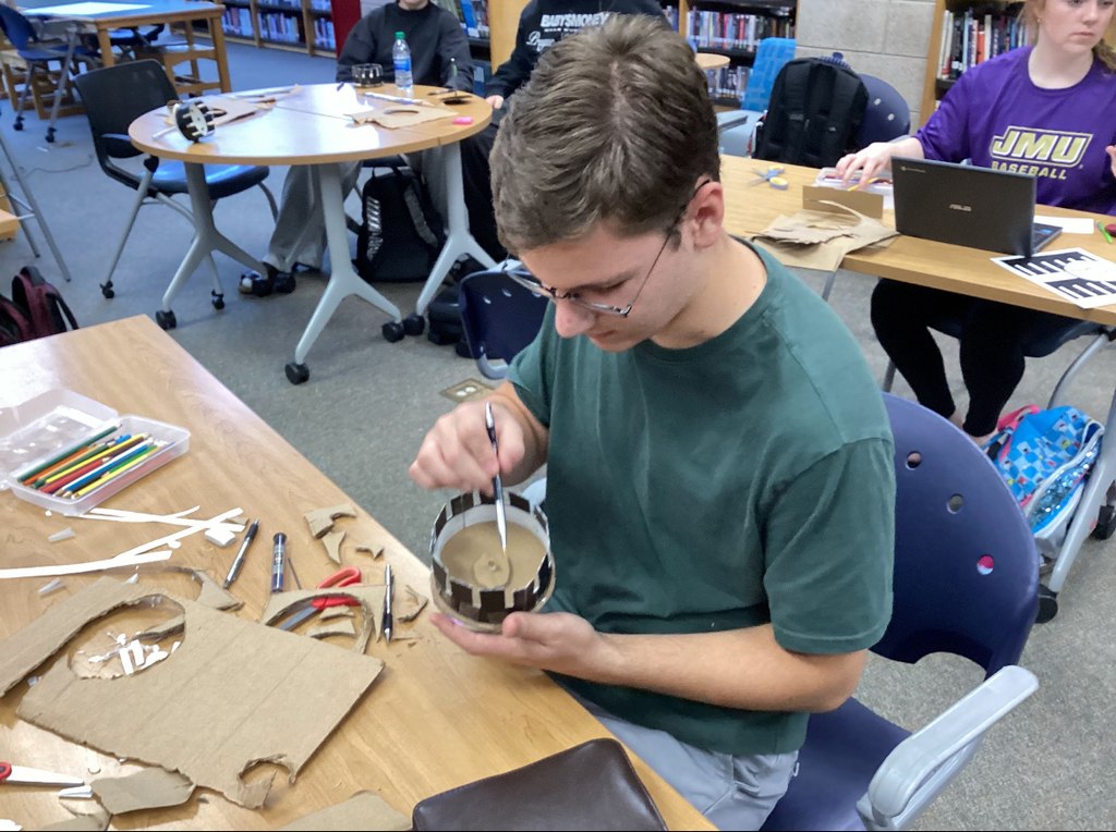 A student builds a zoetrope in an intro to film class.