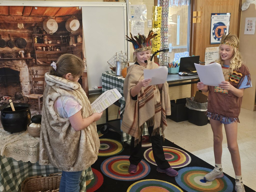 Students in costume perform in a Jamestown reader’s theater skit.