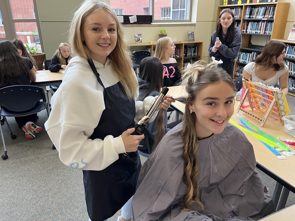 Two teens pose for a photo at a high school spookfest. 