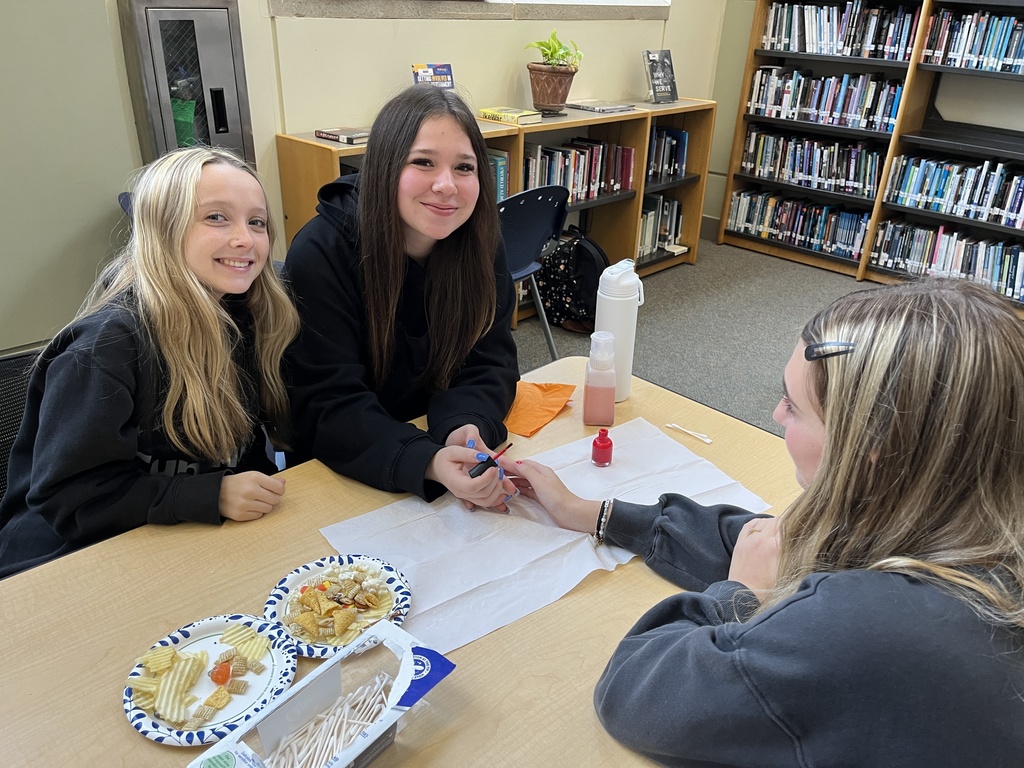 Two teens pose for a photo at a high school spookfest. 