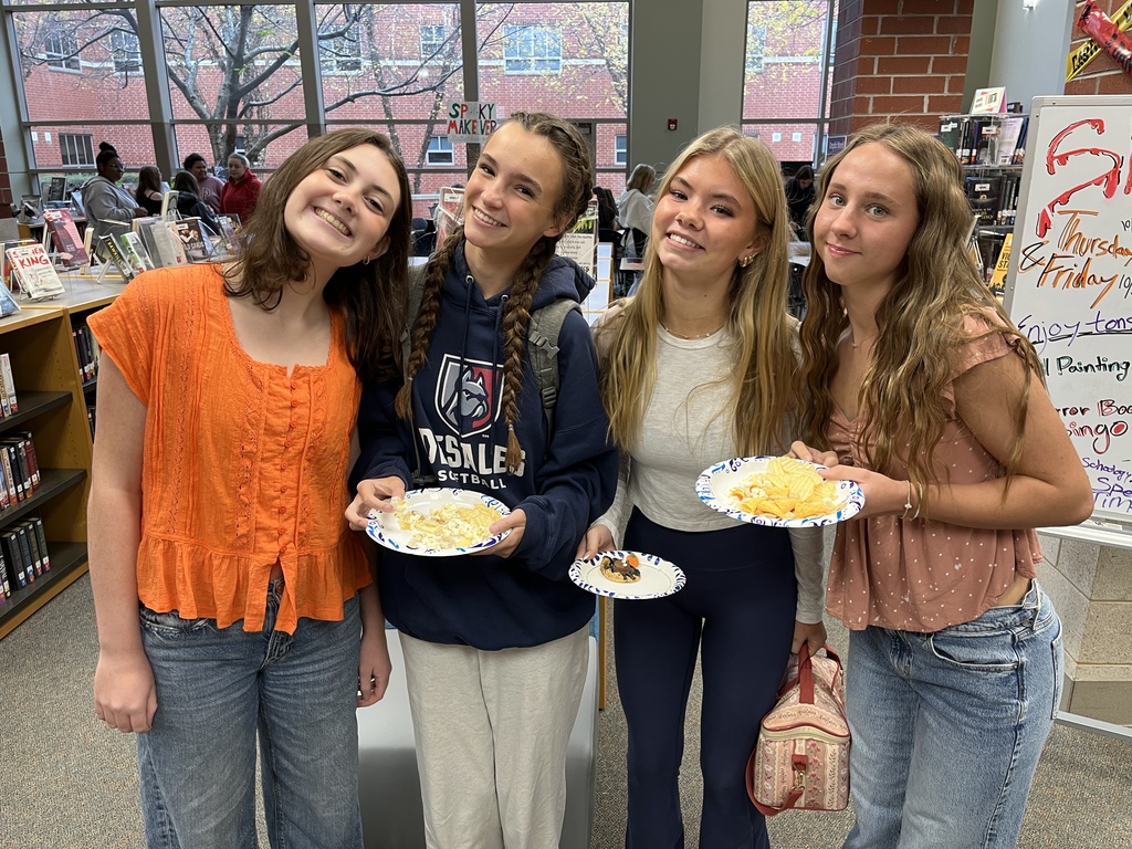 Four teens pose for a photo at a high school spookfest. 