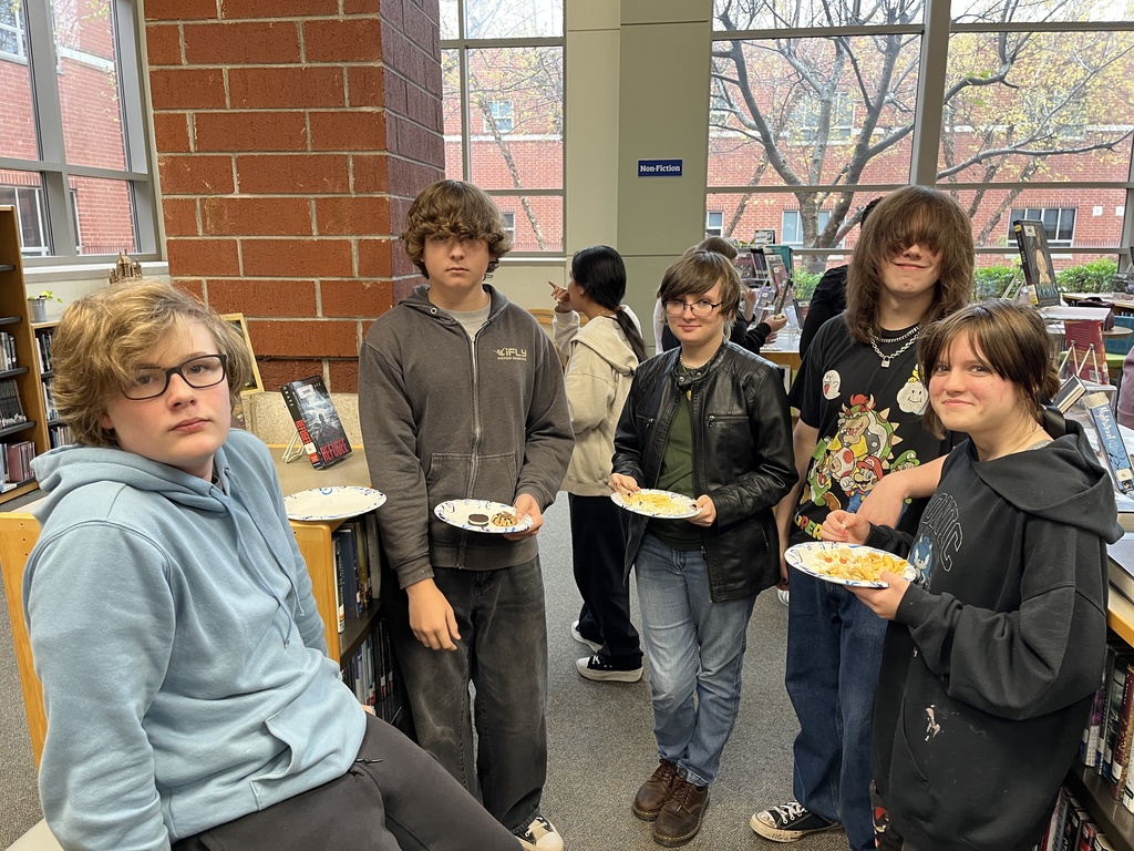 Five  teens pose for a photo at a high school spookfest. 