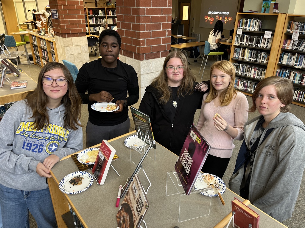 Five teens pose for a photo at a high school spookfest. 