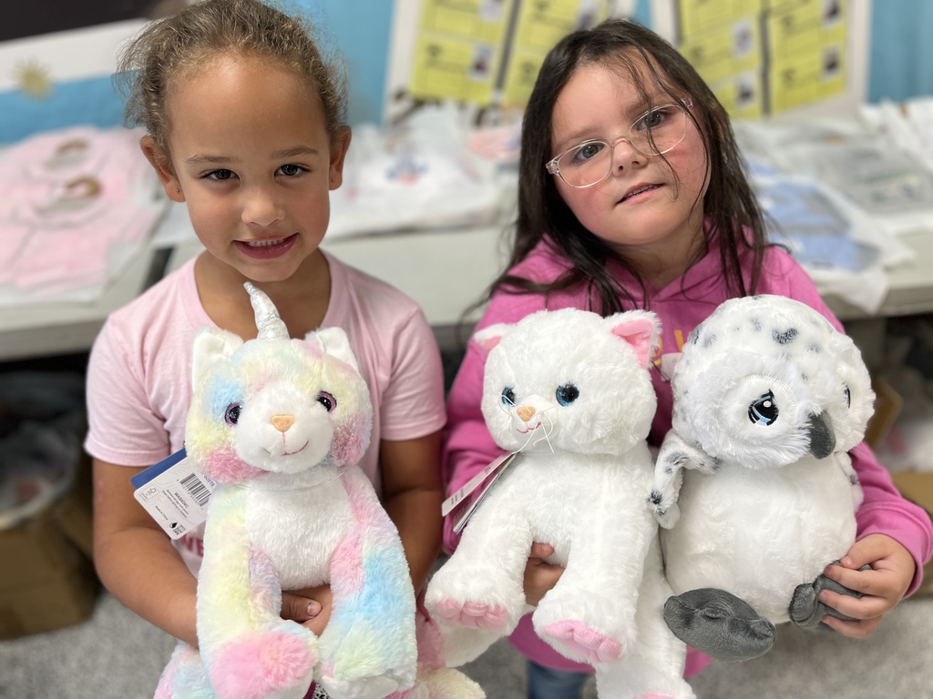 Students pose with a stuffed animal earned in a fundraiser.