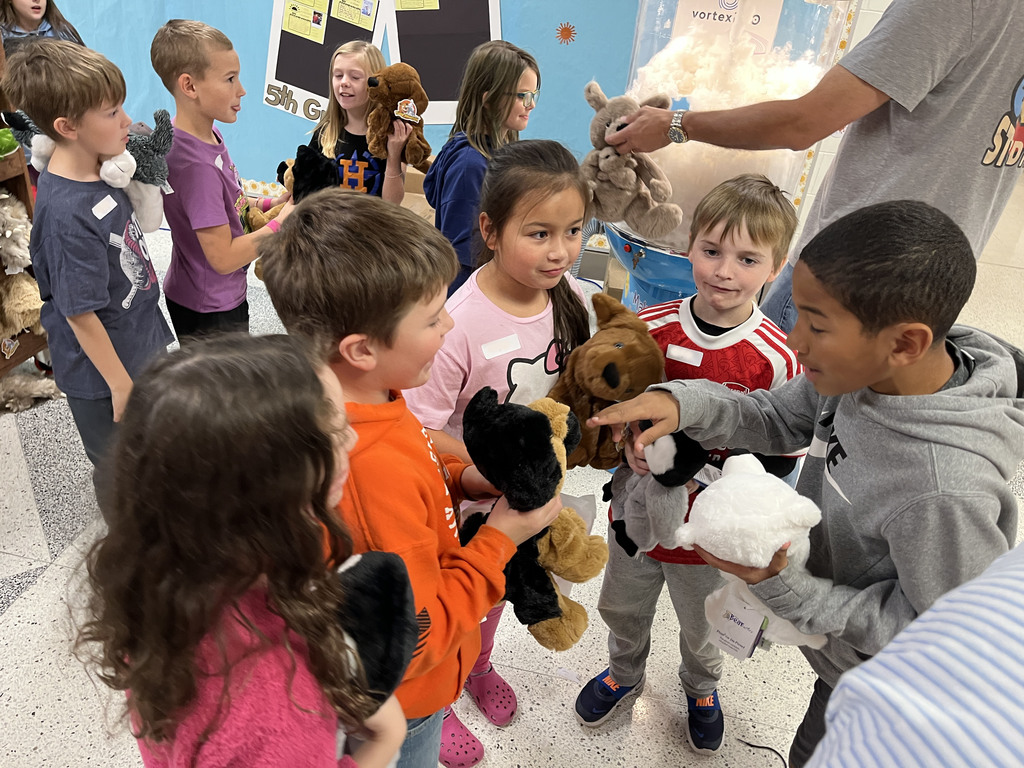 Students compare stuffed animals they earned in a fundraiser.