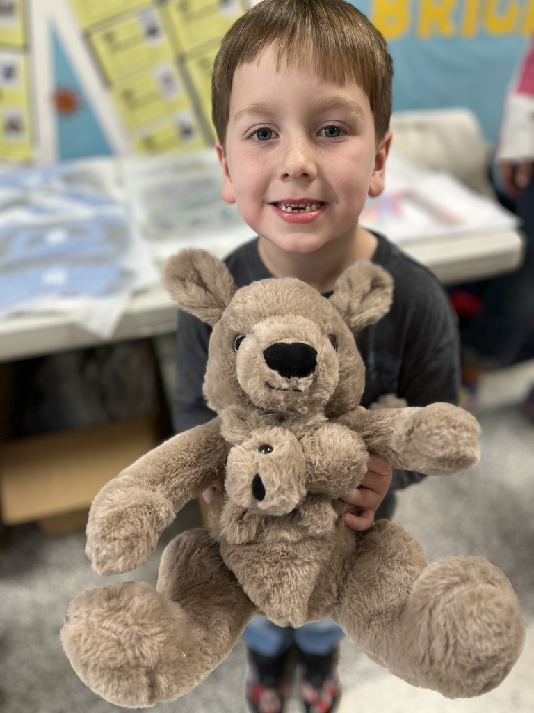 A child poses with a stuffed animal earned in a fundraiser.