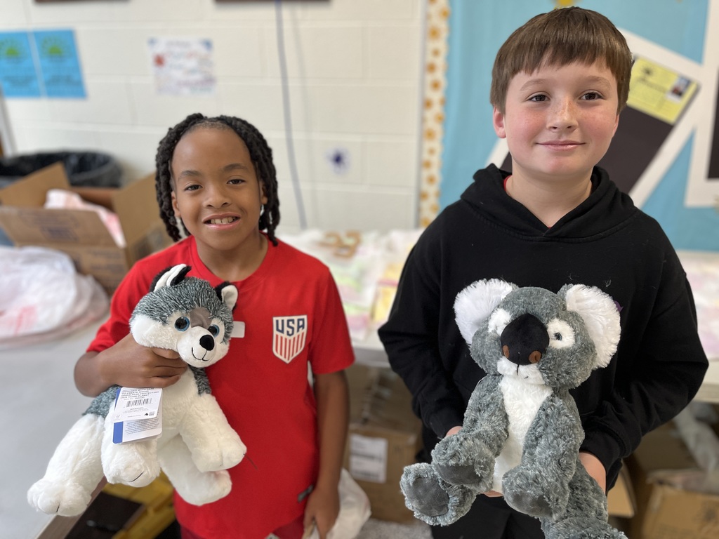 Students pose with a stuffed animal earned in a fundraiser.
