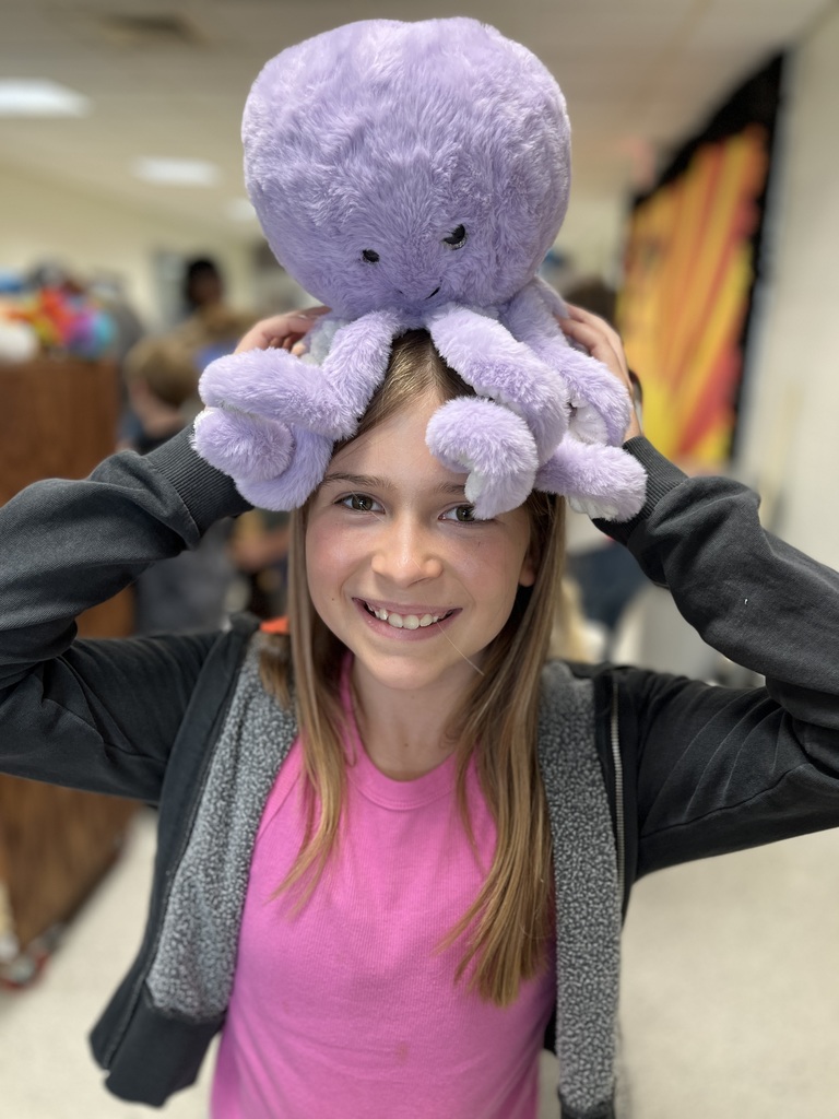 A child poses with a stuffed animal earned in a fundraiser.
