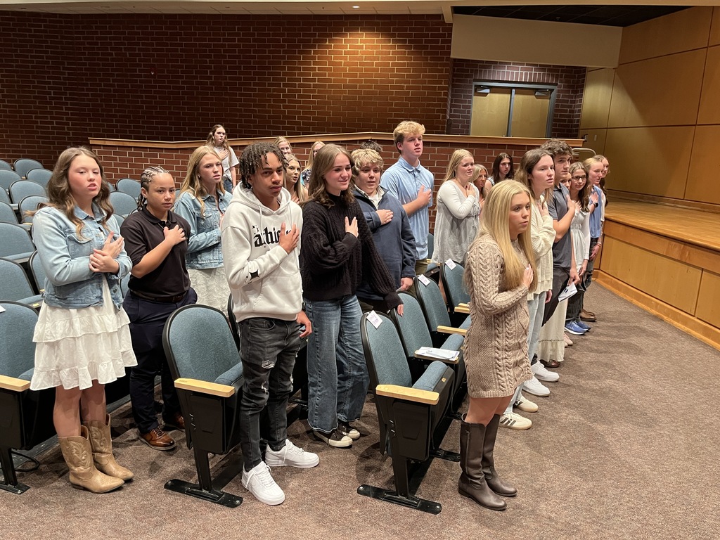 Inductees recite the Pledge of Allegiance during  a National Technical Honor Society induction ceremony.