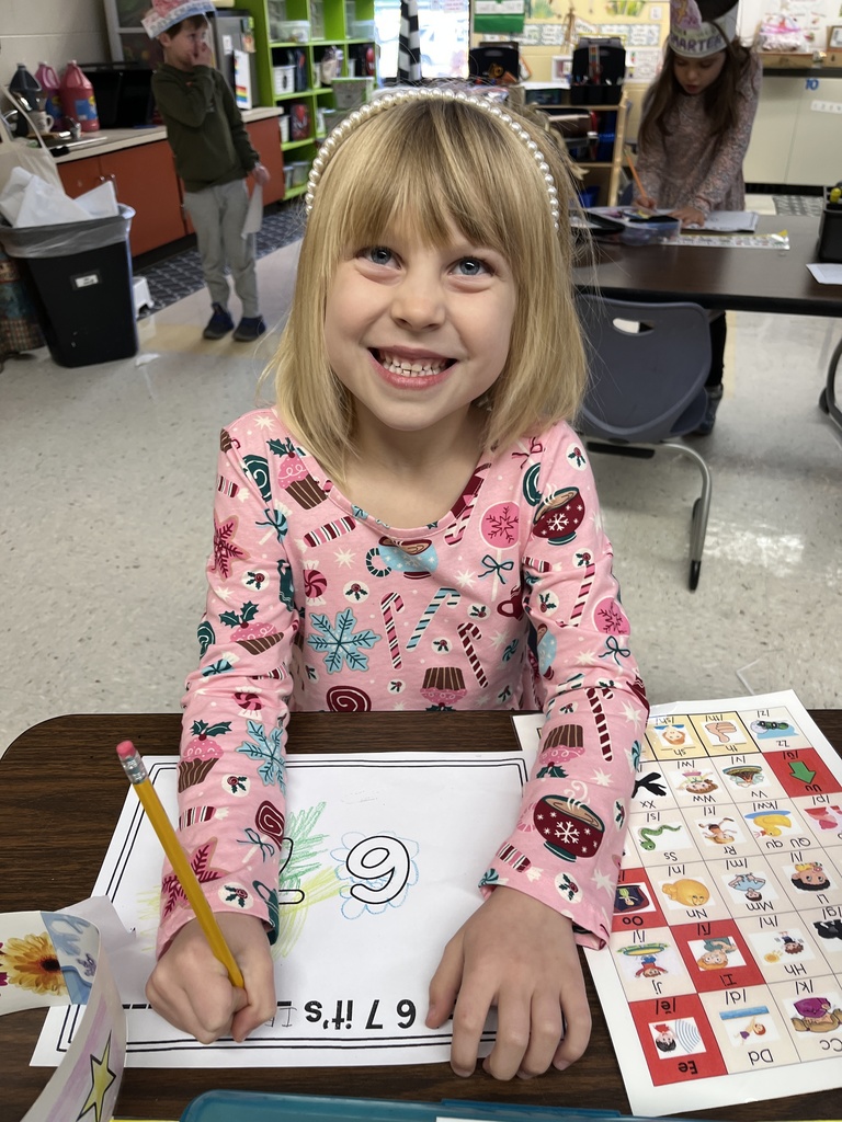 A student in class works on a 67th day of school activity. 