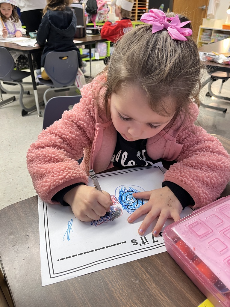 A student in class works on a 67th day of school activity. 