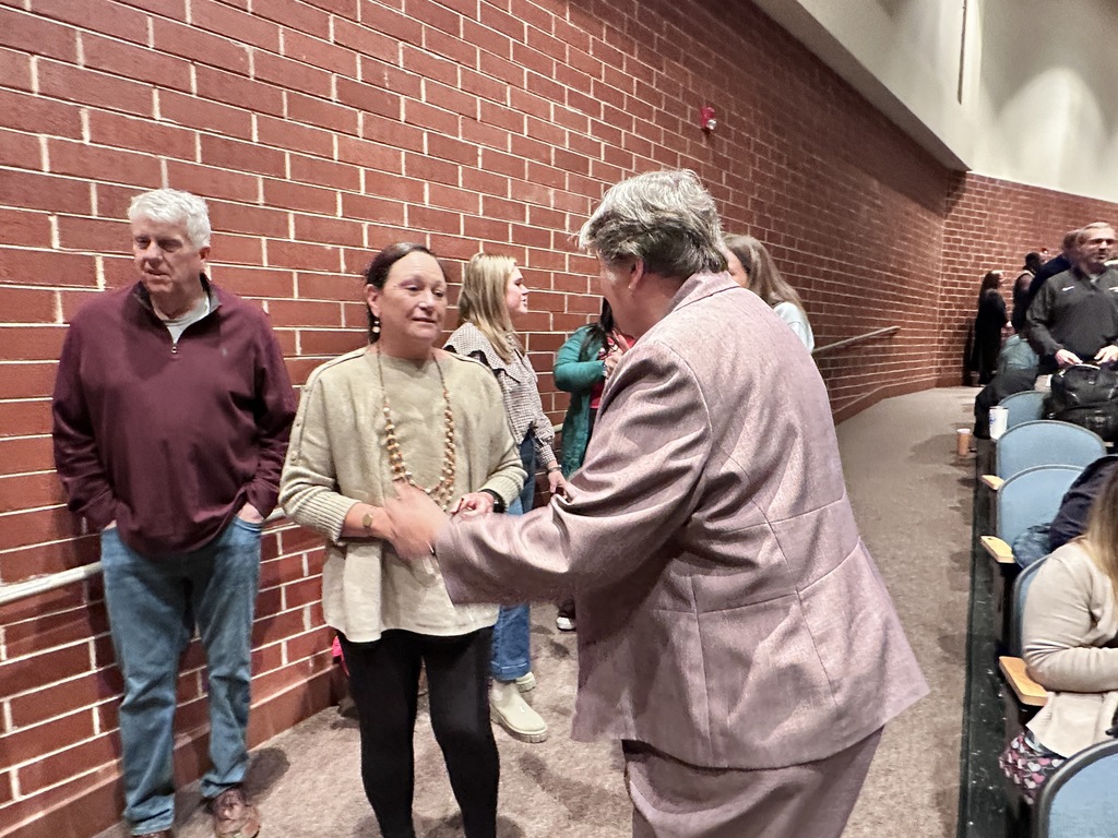 One woman goes to hug another