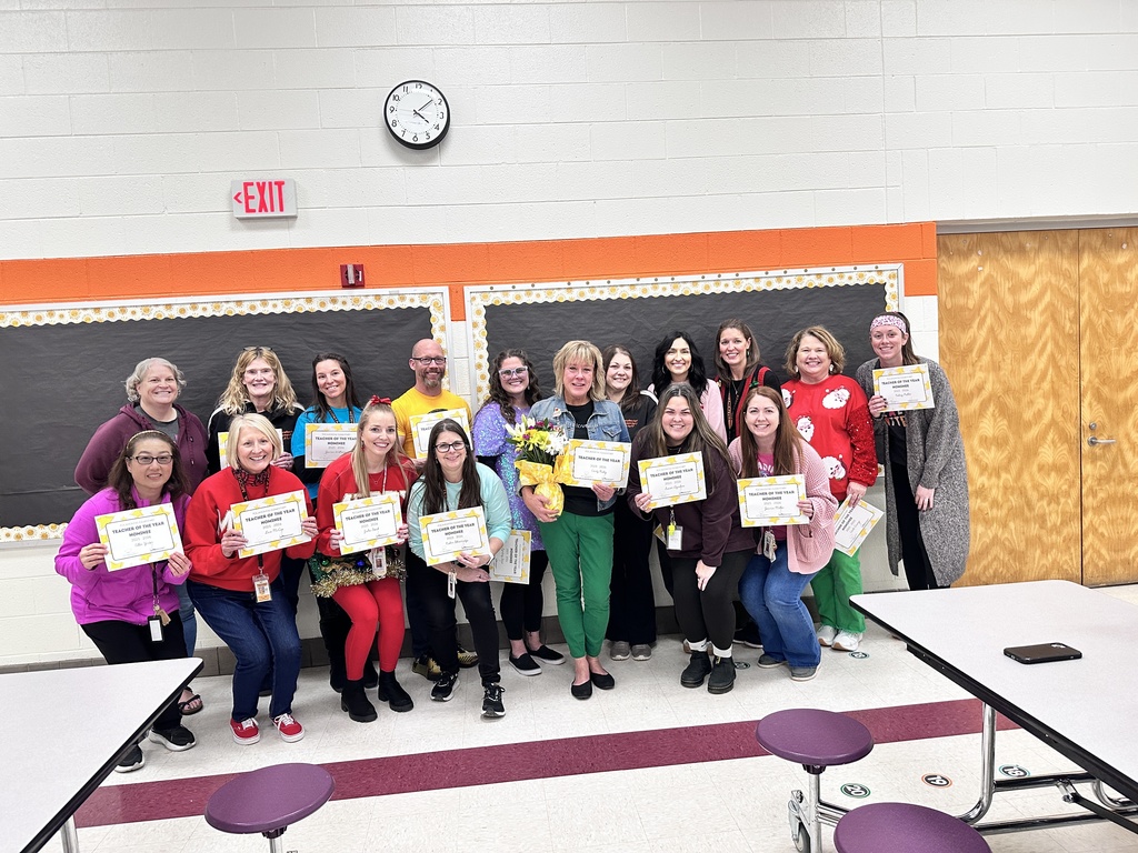 A group of women and one man pose for a photo holding certificates..