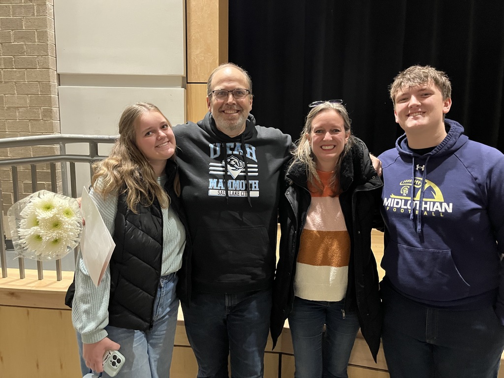 A man who has been named teacher of the year is celebrated by his family members. 