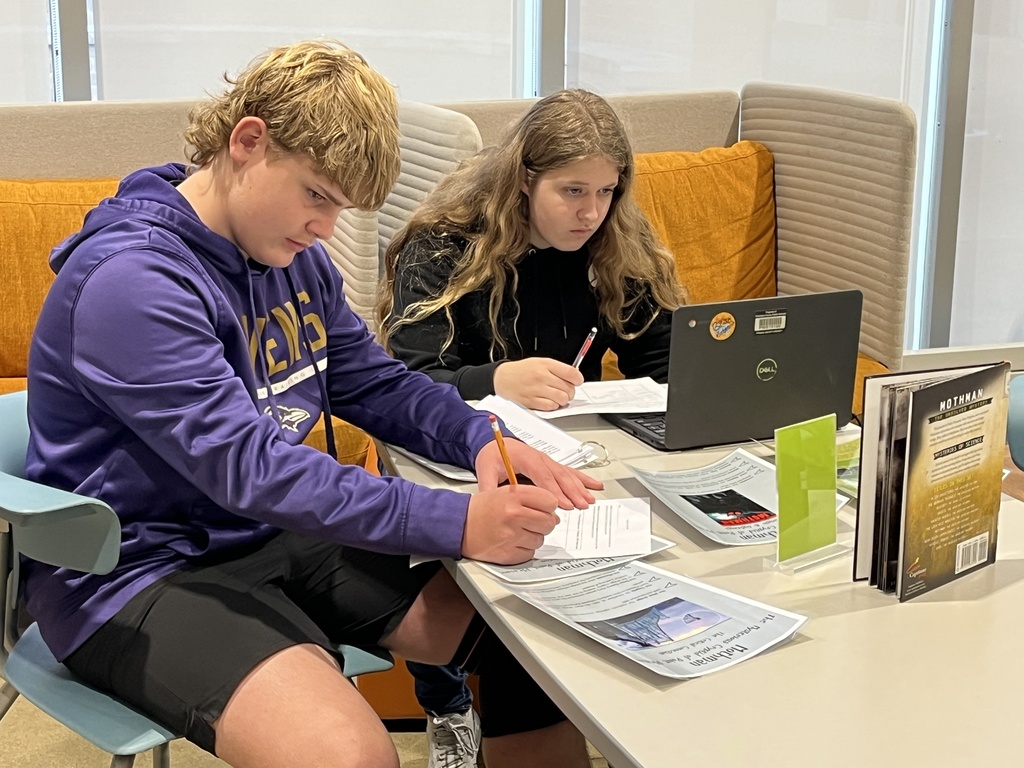 Students participate in a Mysteries, Myths, and Monsters research unit  in the library.
