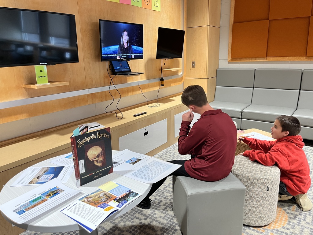 Students participate in a Mysteries, Myths, and Monsters research unit  in the library.