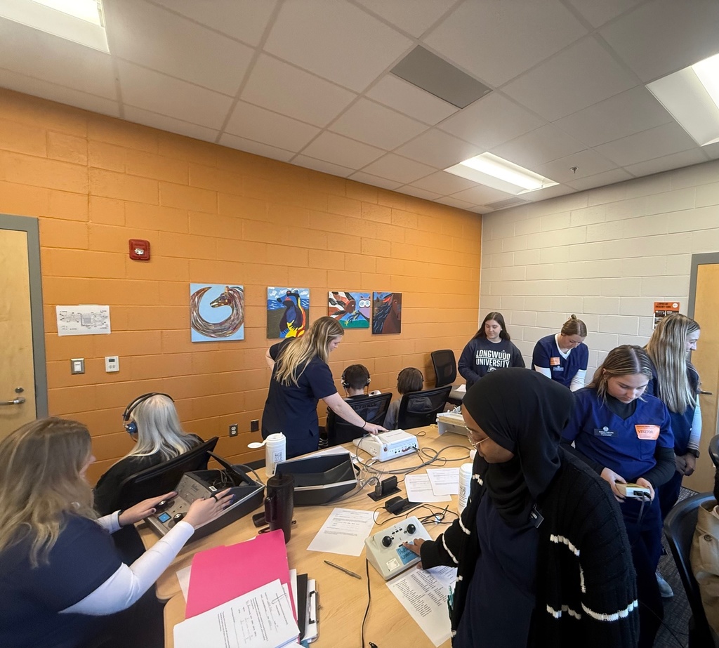 College students conduct hearing tests at a middle school.