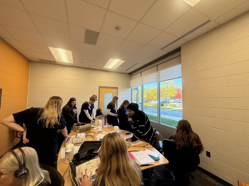 College students conduct hearing tests at a middle school.