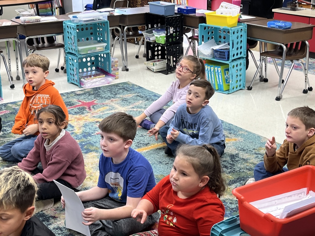 Students listen to a lesson on the different ways the letter Y can sound in a word.