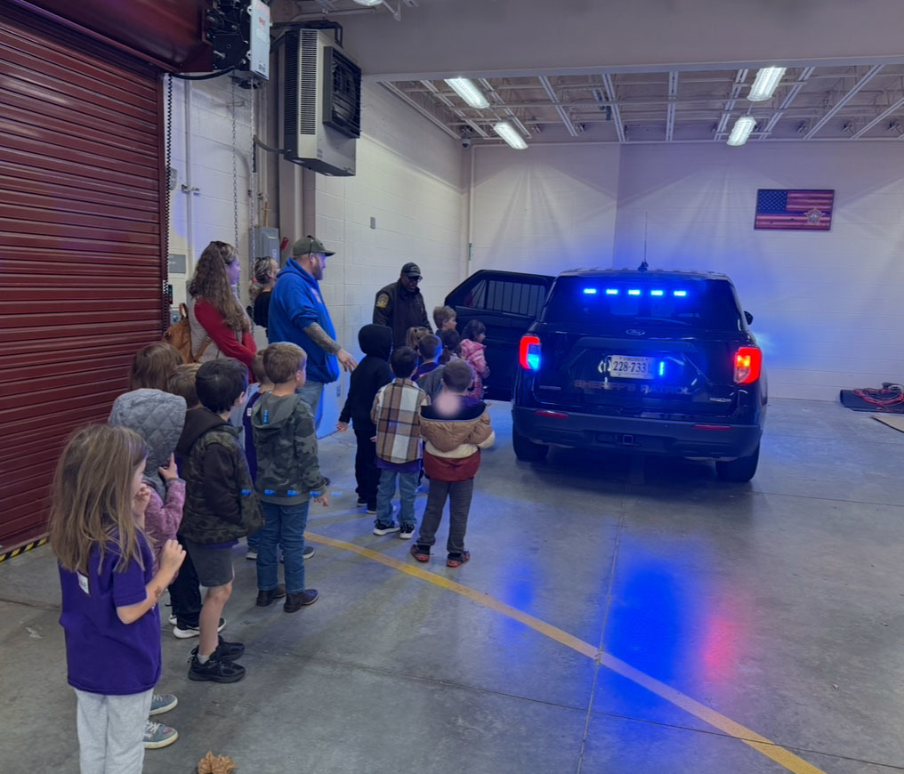 A kindergarten class  takes a tour of a sheriff's office.