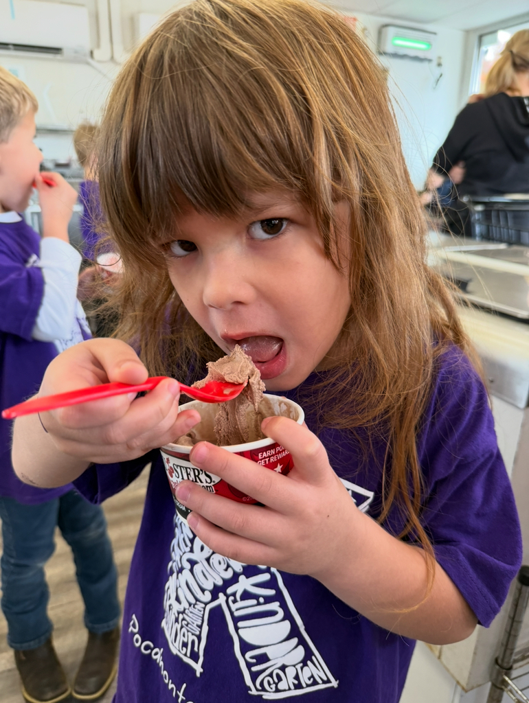 A child eats a cup of ice cream.