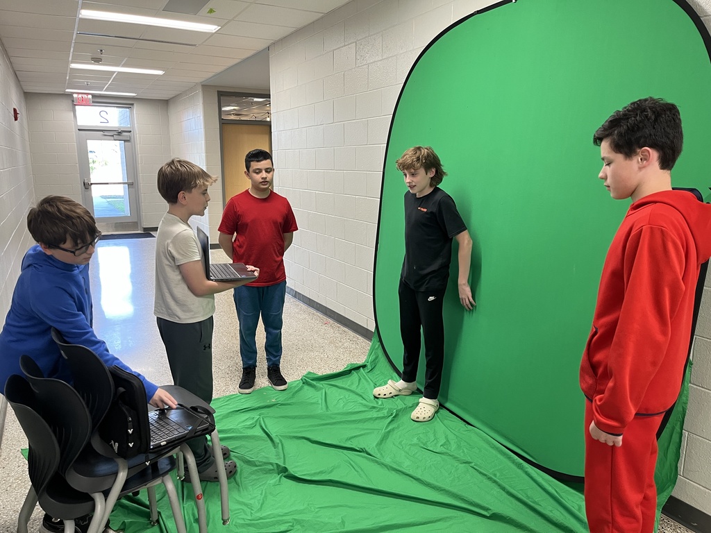 Students work with a green screen as part of a weather forecast production unit. 