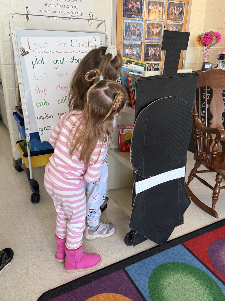 Children look at a cart of books.