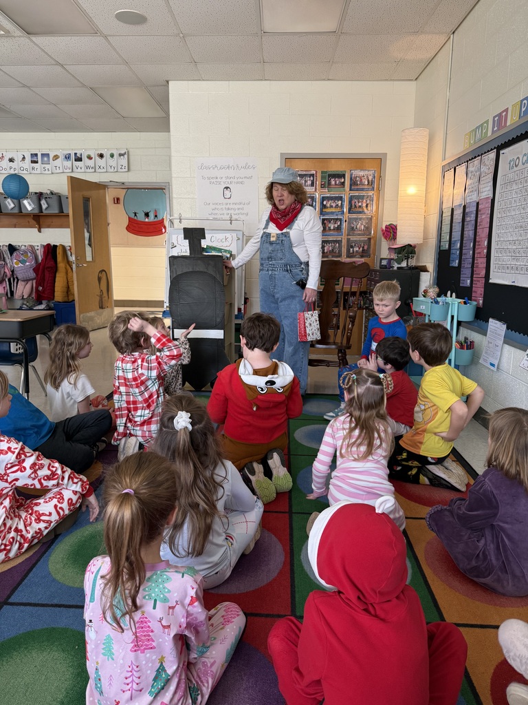 A conductor speaks to a group of children on Polar Express Day.