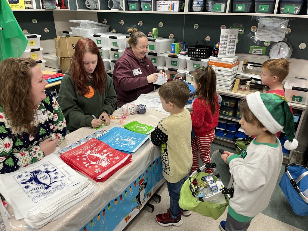 Volunteers help students at a PTO-run holiday shop.