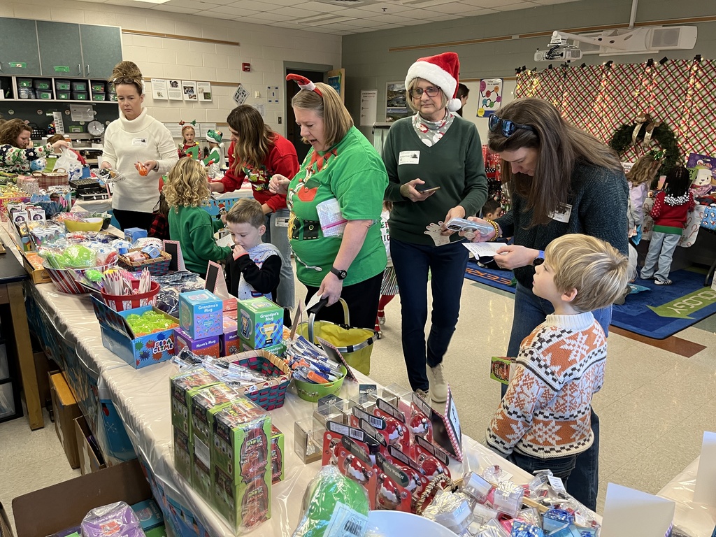 Volunteers help students at a PTO-run holiday shop.