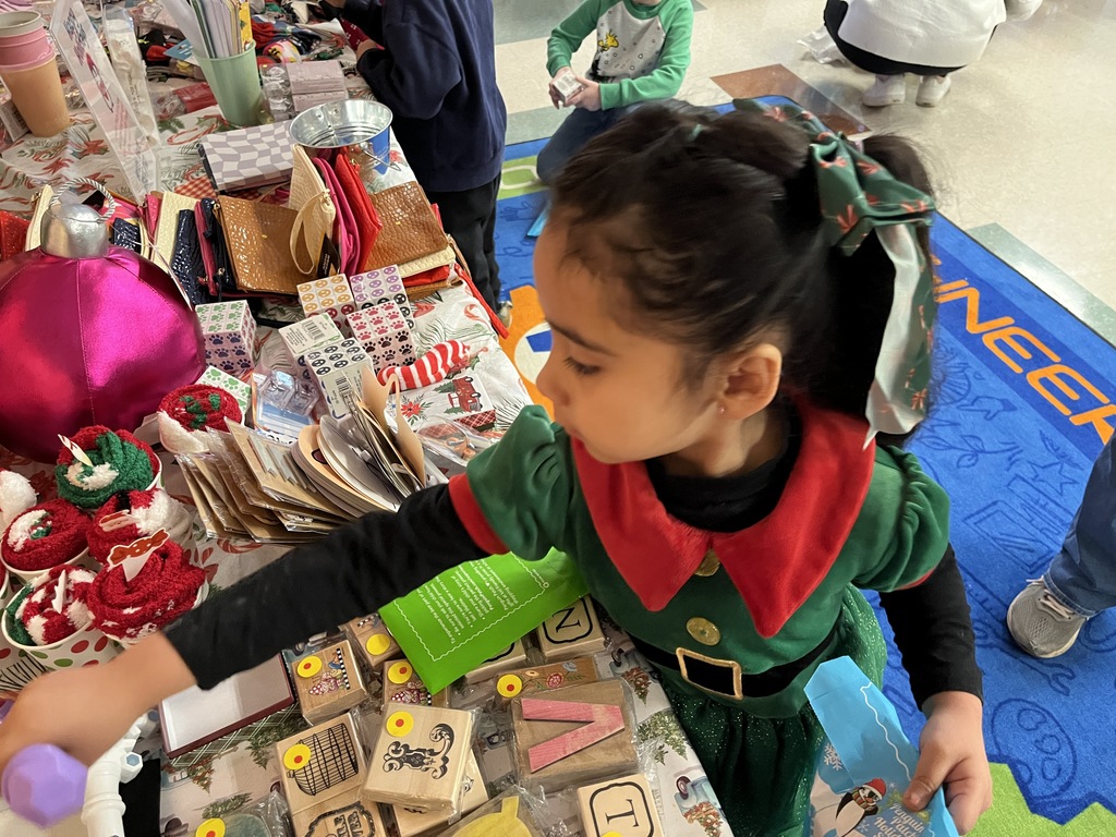 A student shops at a PTO-run holiday shop.