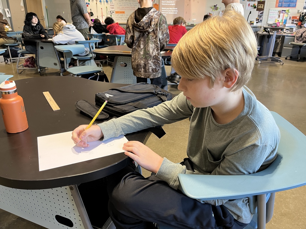 A student works on a mars rover related assignment in science class. 