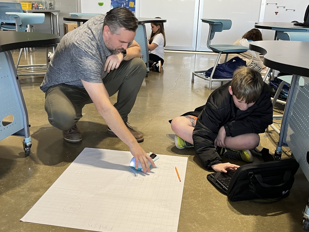 A teacher helps a student with an assignment. 