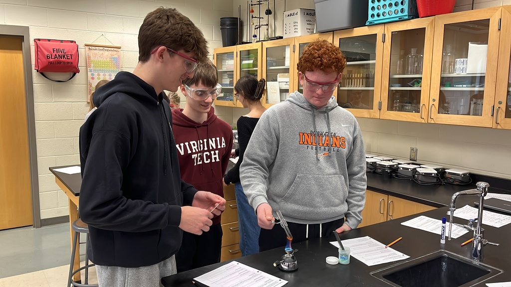 Students in chemistry class test chemical reactions.