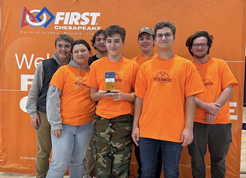 A robotics team poses for a photo.