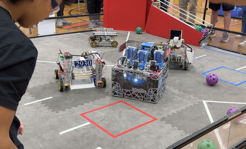 Robots in a competition ring at a robotics competition.