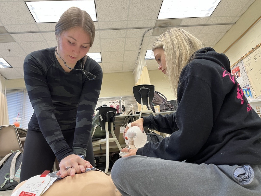 Students practice performing CPR.