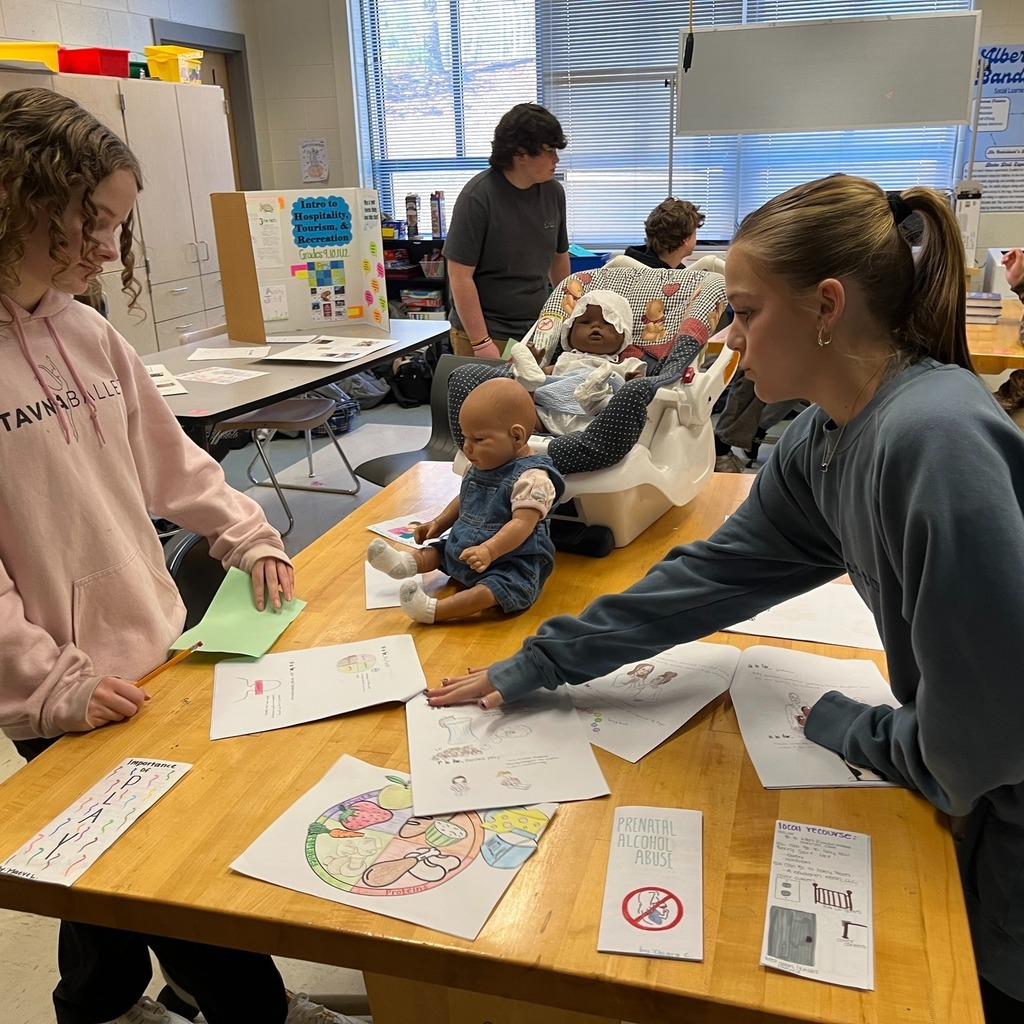 Teach for tomorrow students look over literature.