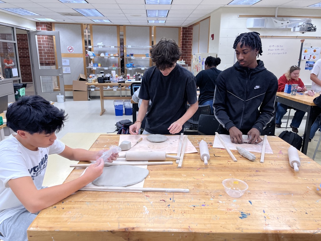 Students in ceramics class work on projects.