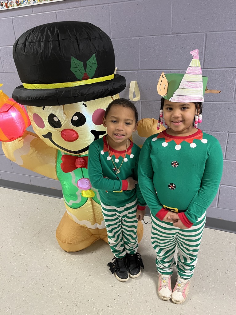 Students in matching pajamas pose for a photo.