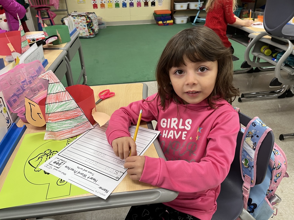 A student works at her desk on writing practice.