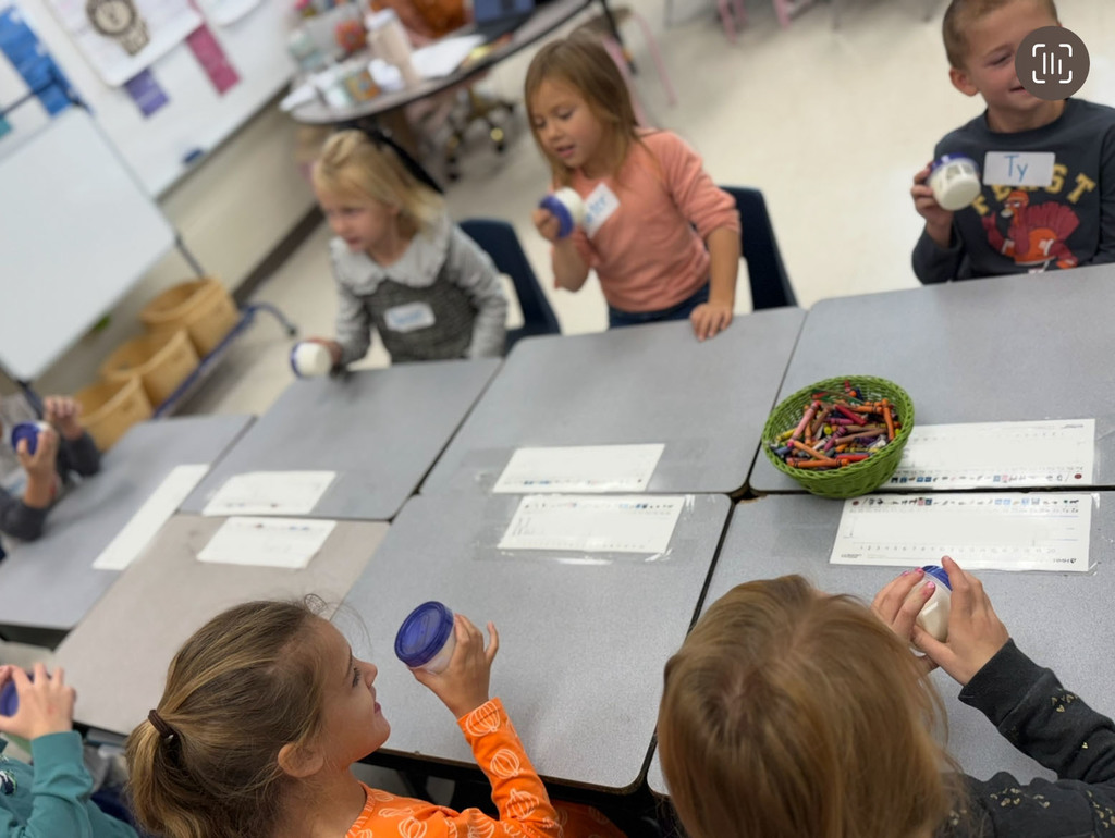 First graders participate in a colonial craft day activity. 