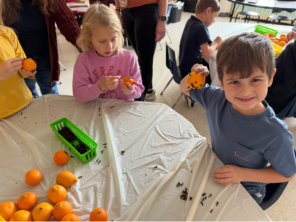 First graders participate in a colonial craft day activity. 
