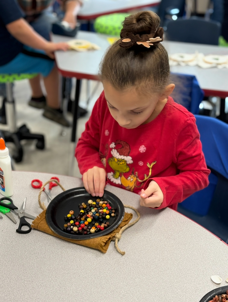 A first grader participates in a colonial craft day activity. 