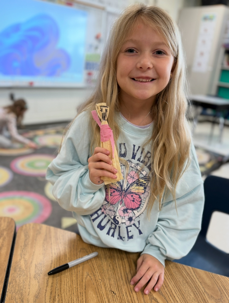 A first grader participates in a colonial craft day activity. 