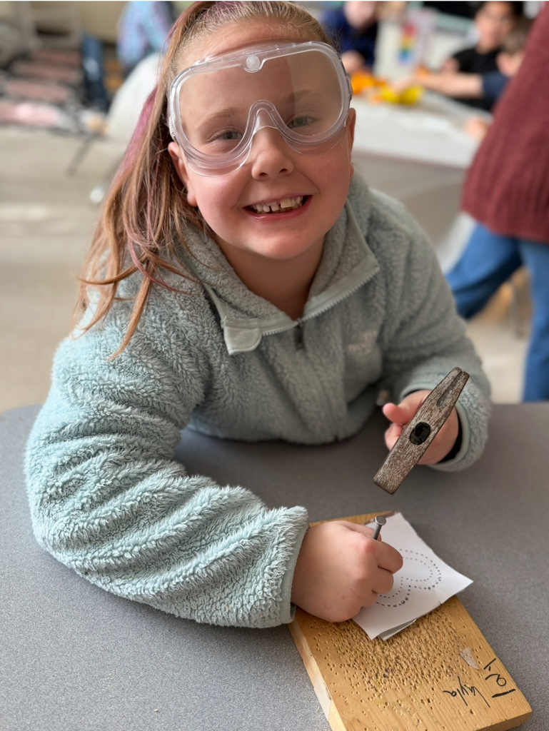 A first grader participates in a colonial craft day activity. 
